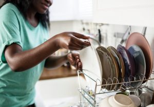 Young woman washing dishses