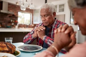 Man and woman praying before a meal