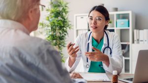 Older man talking with doctor about health