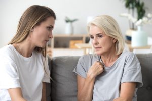 Two women sitting together, discussing a serious topic