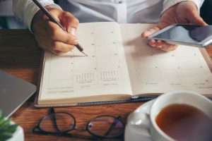 Man writing in day planner