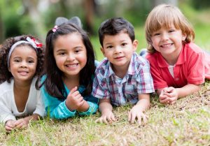 Group of four children smiling at the camera