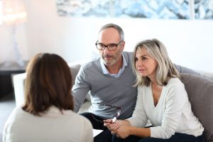 Husband and wife talking to estate planning expert