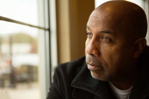 Solemn man sitting alone, thinking