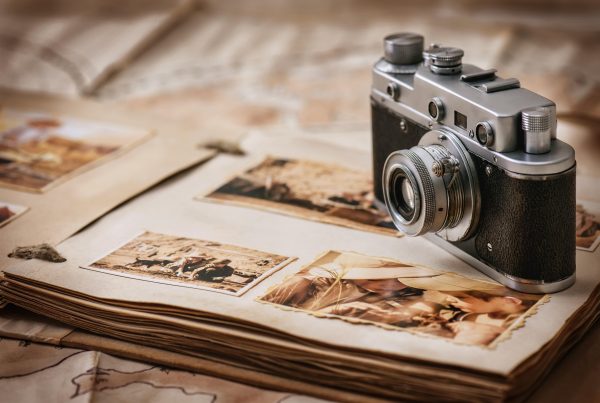 Camera sitting on top of photo album