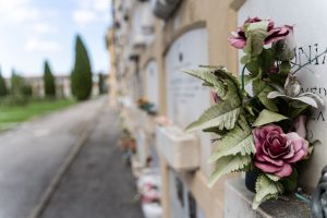 Columbarium wall with plaques and flowers