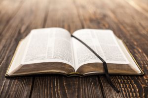 Bible laying open on wooden table