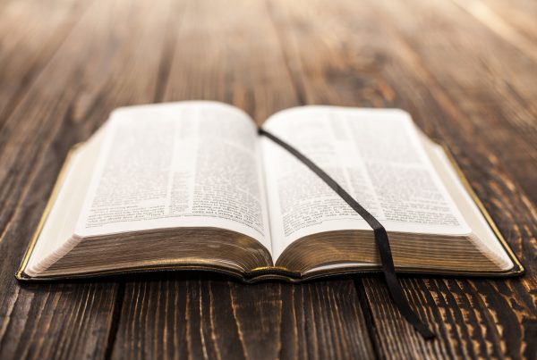 Bible laying open on wooden table