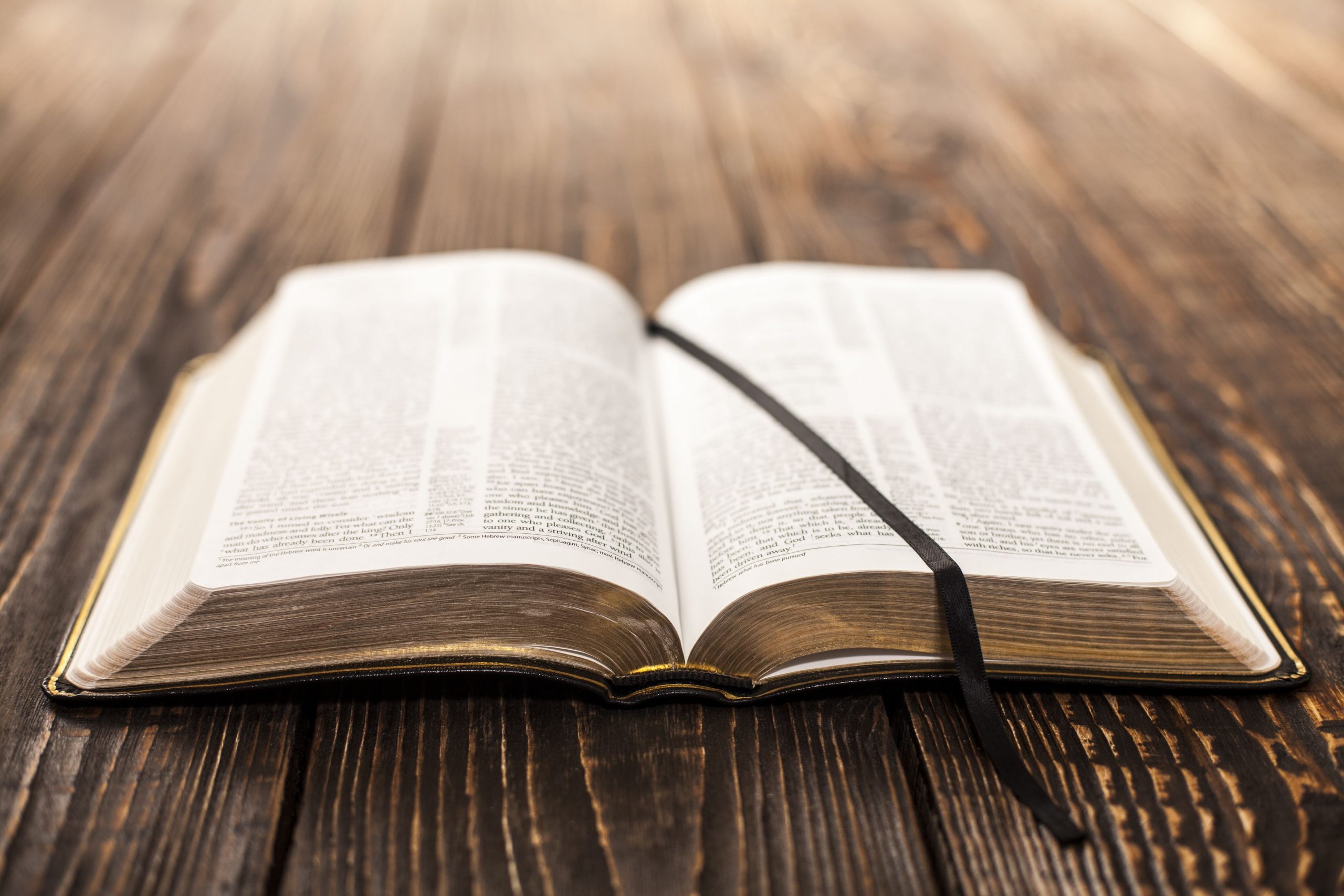 Bible laying open on wooden table