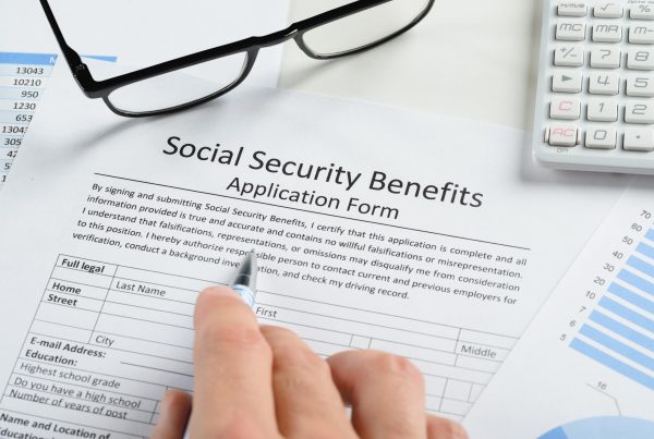 Person filling out Social Security Benefits Application Form