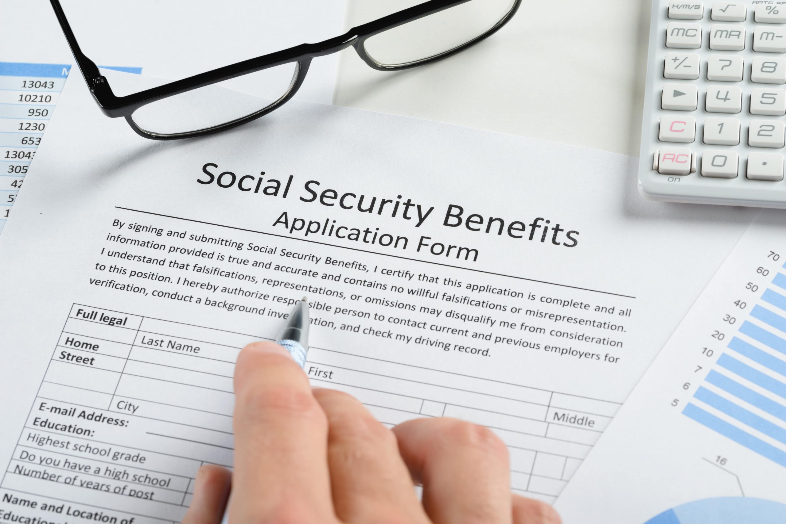 Person filling out Social Security Benefits Application Form