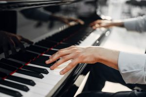 Man playing piano, focus on hands