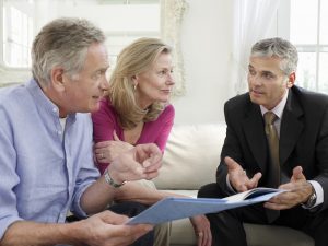 To show a couple discussing plans with a funeral director