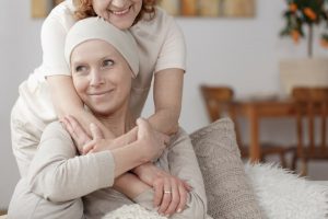 Shows patient receiving hug from caregiver