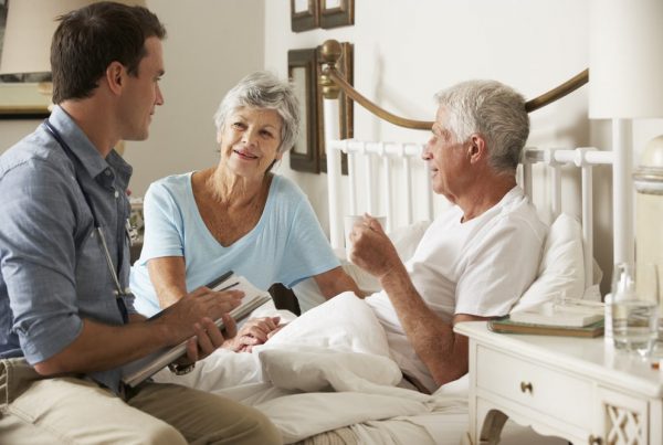 Man and wife receiving a doctor's care at home