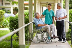 Shows a caring nurse looking at a patient while a family member looks on