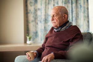 confused older man sitting alone