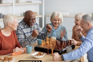 group of elderly friends laughing together