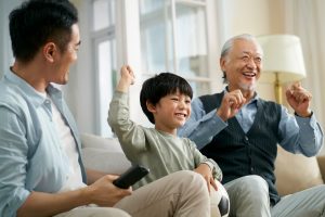 family playing watching games together and laughing