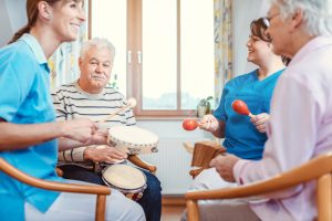 circle of people in hospice playing musical instruments