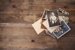 old photographs laying on a wooden table