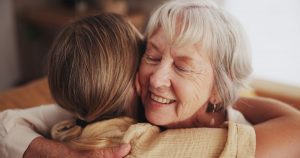 Grandmotherly woman hugging a granddaughter